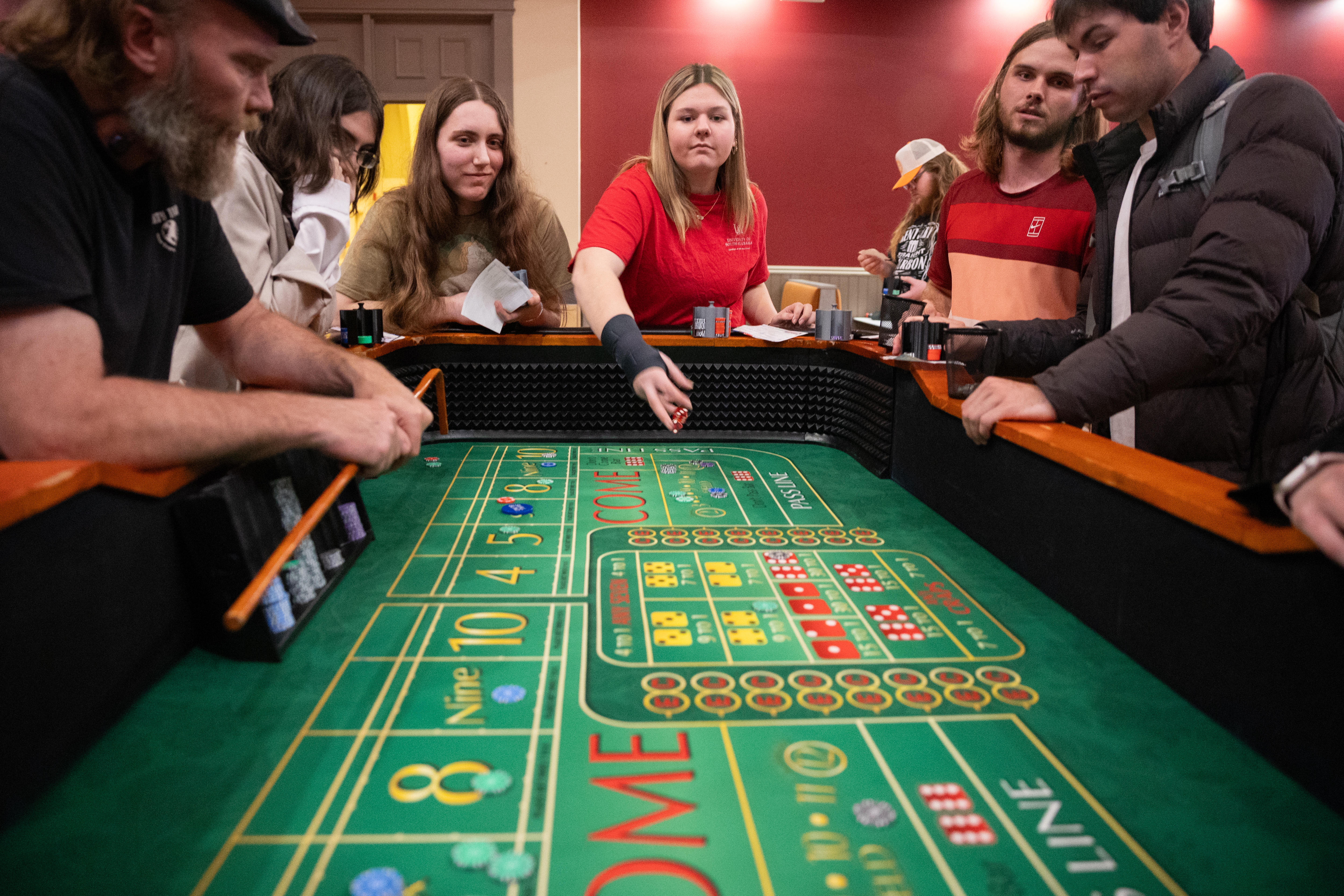 Players rolling die at the craps table